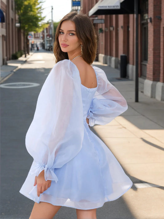 Side profile of the short A-Line homecoming dress, showcasing puff sleeves and ruffled skirt.