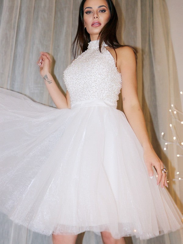 Side view of the beaded halter neckline on the mini dress.