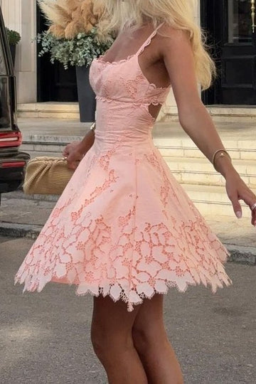 Close-up of scalloped sweetheart neckline on blush pink short dress.