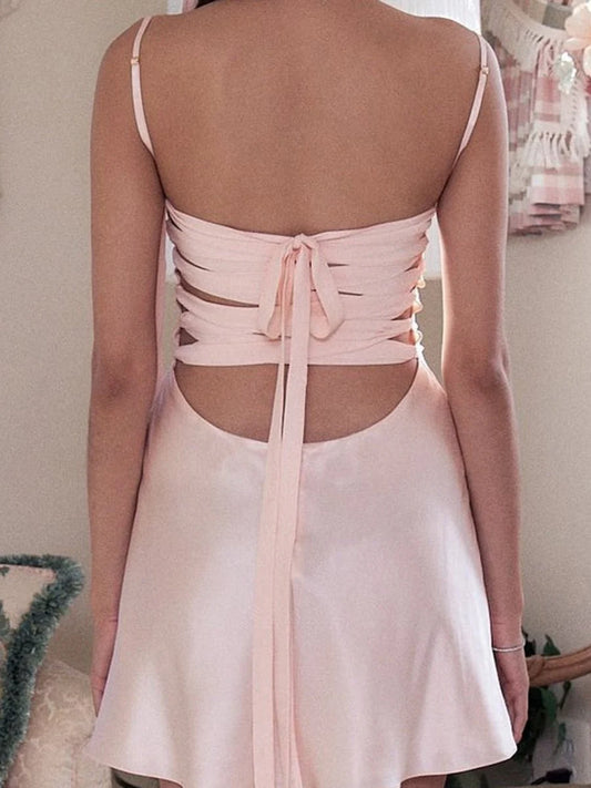 Side view of a satin A-line short homecoming dress showing spaghetti straps.