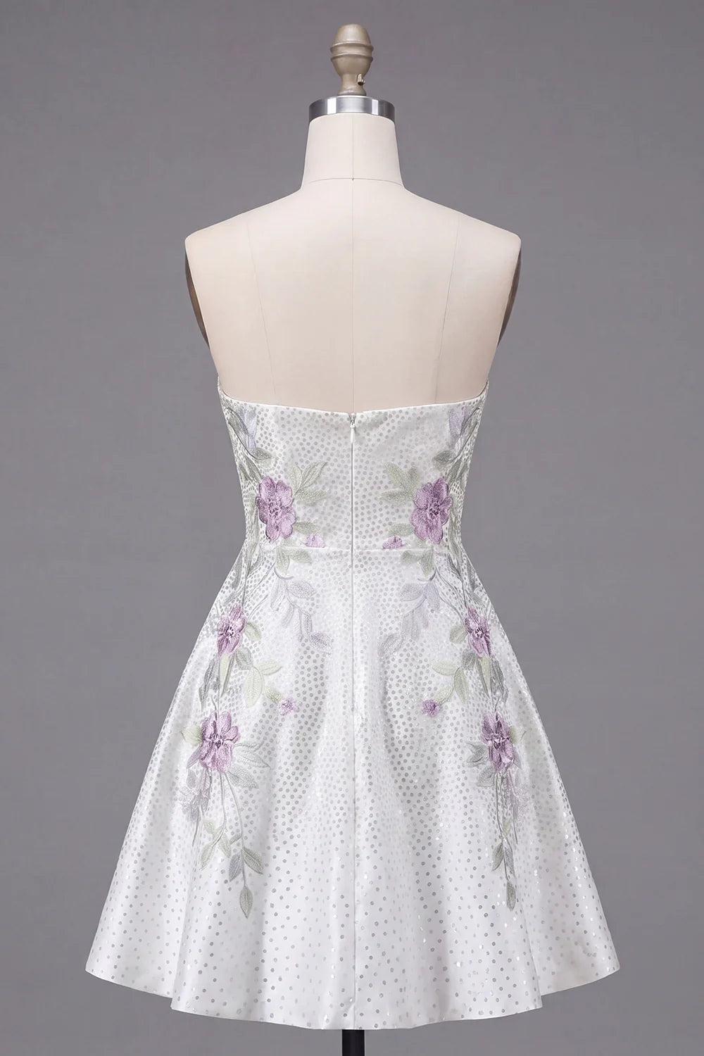 White strapless dress with sweetheart neckline and floral details.