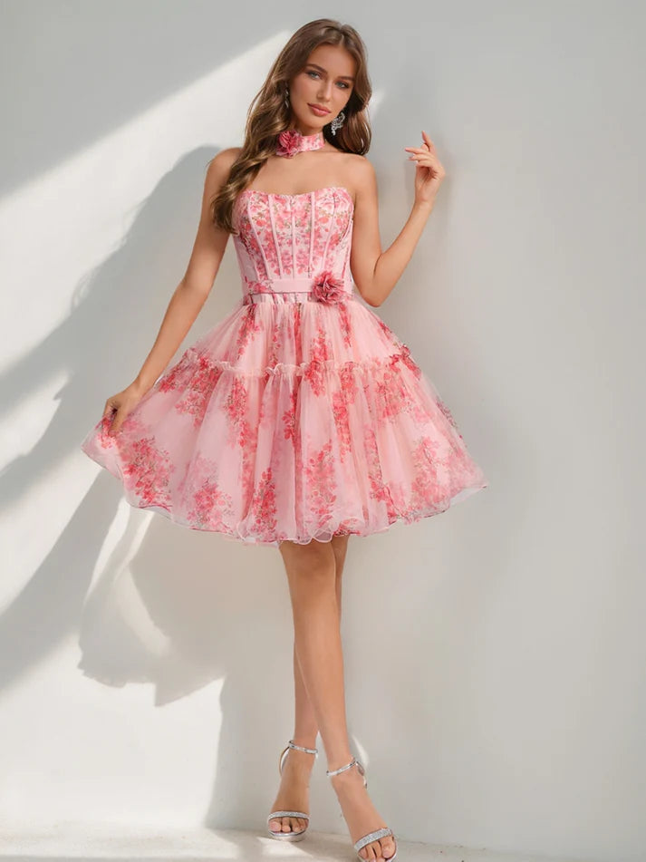 Side view of a model posing in a short A-line floral homecoming dress.