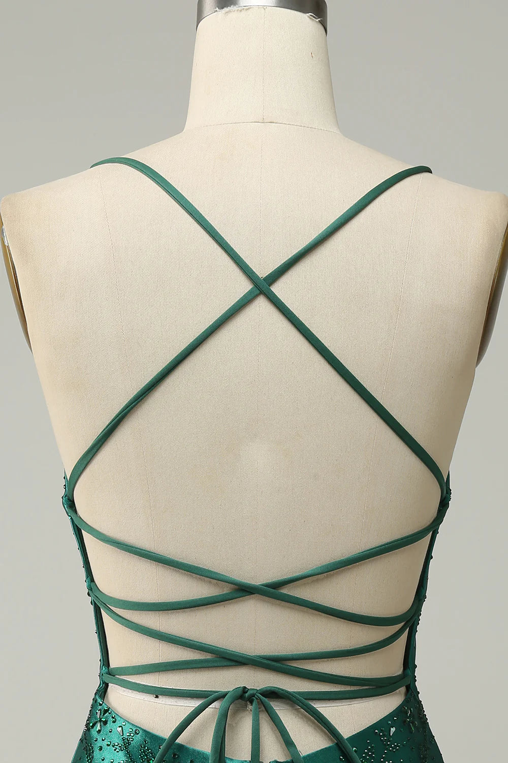 Close-up of the dark green beaded fabric on the bodycon dress.