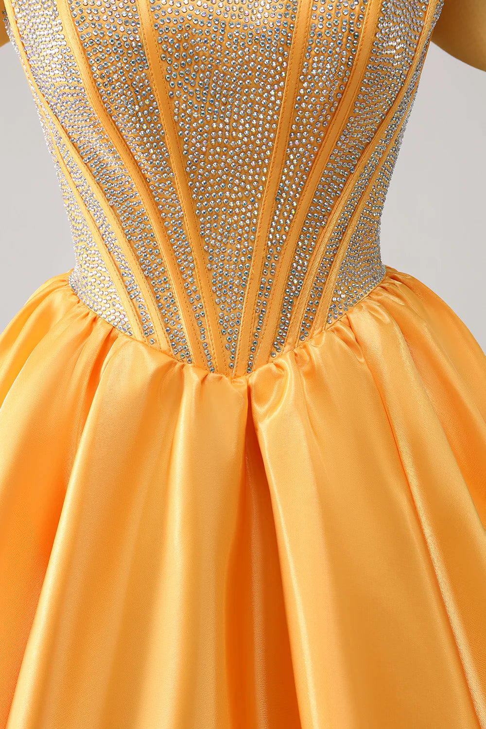Full length view of a yellow A-line off-shoulder beaded satin gown.