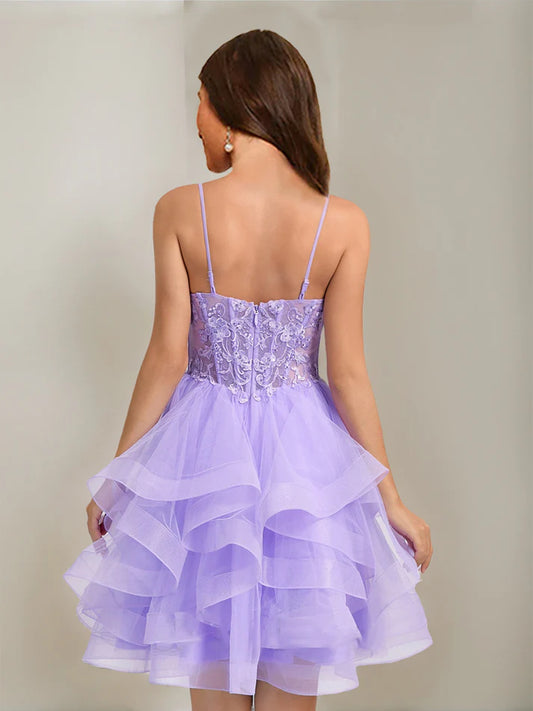Side view of an elegant short beaded tulle ball gown homecoming dress with spaghetti straps.