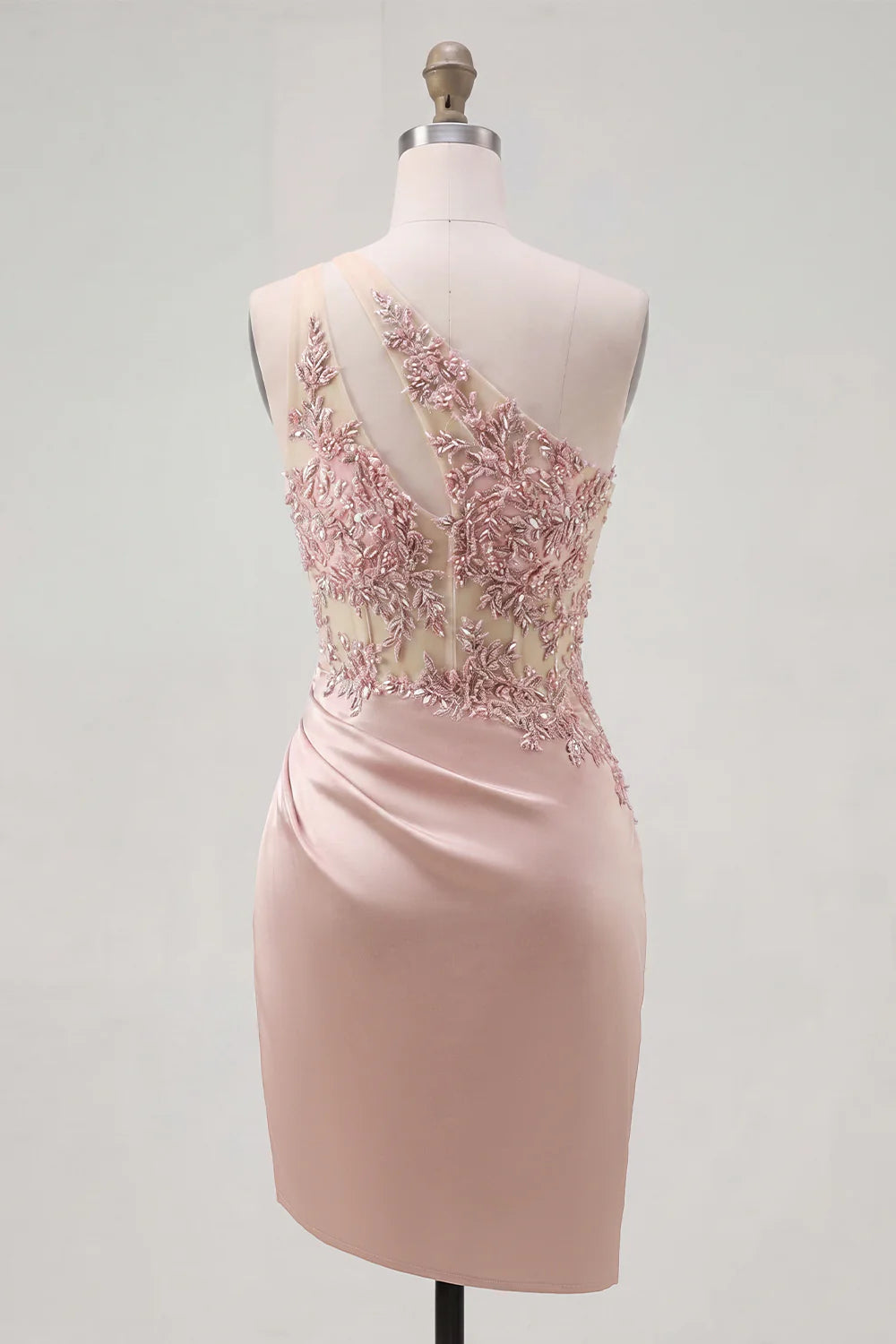 Full view of the blush pink one-shoulder homecoming dress with cutout and lace details.