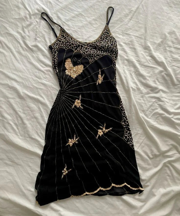 Woman wearing a vintage Art Deco inspired gold beaded bodycon midi homecoming dress with V-neck and butterfly motifs.
