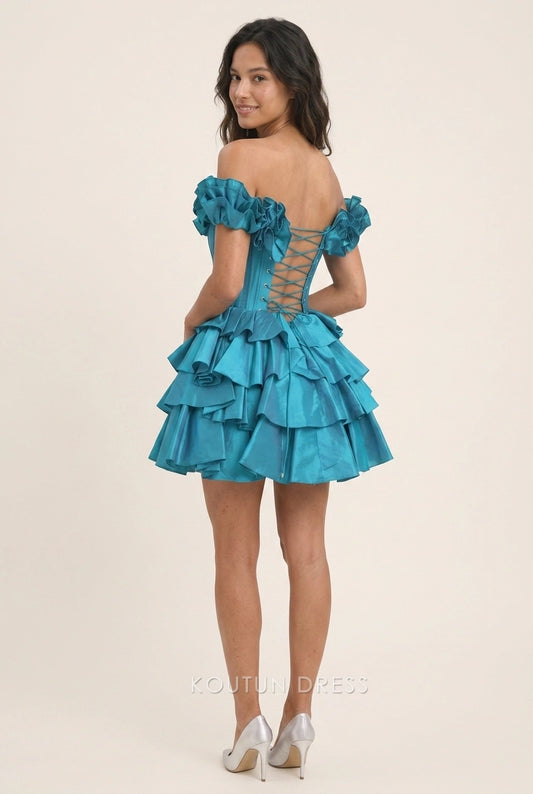 Back view of a teal off-shoulder ruffled mini dress, showing the lace-up corset detail.