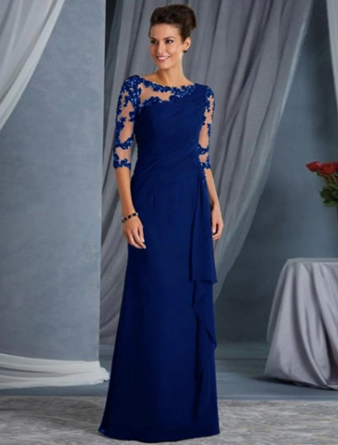 Detail of the half sleeves and intricate lace design on the evening dress.