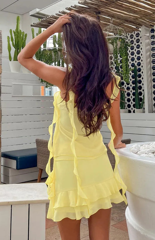 Back view of the elegant spaghetti strap chiffon mini dress on a model.