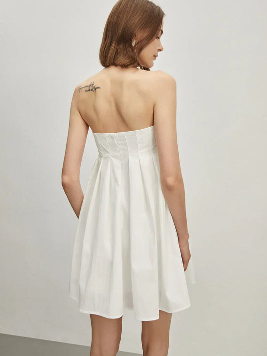 Back view of white strapless empire waist mini dress.