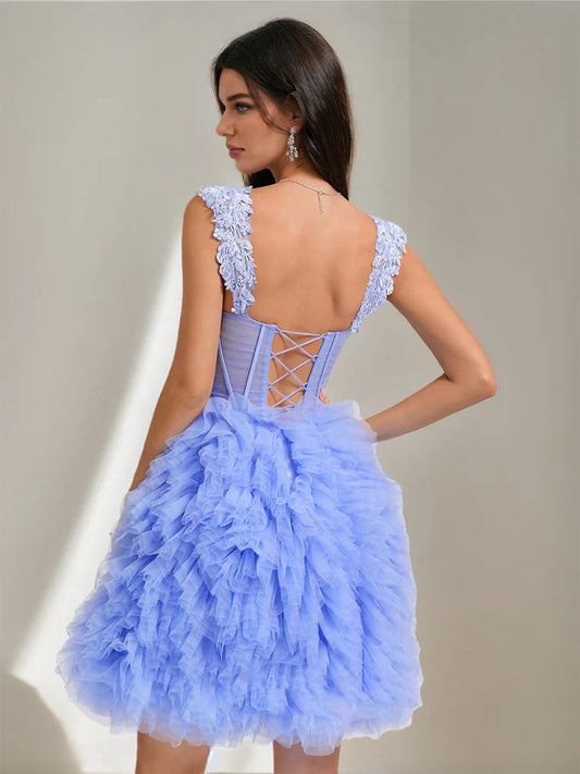 Back view of a short tulle homecoming dress featuring a pleated skirt.
