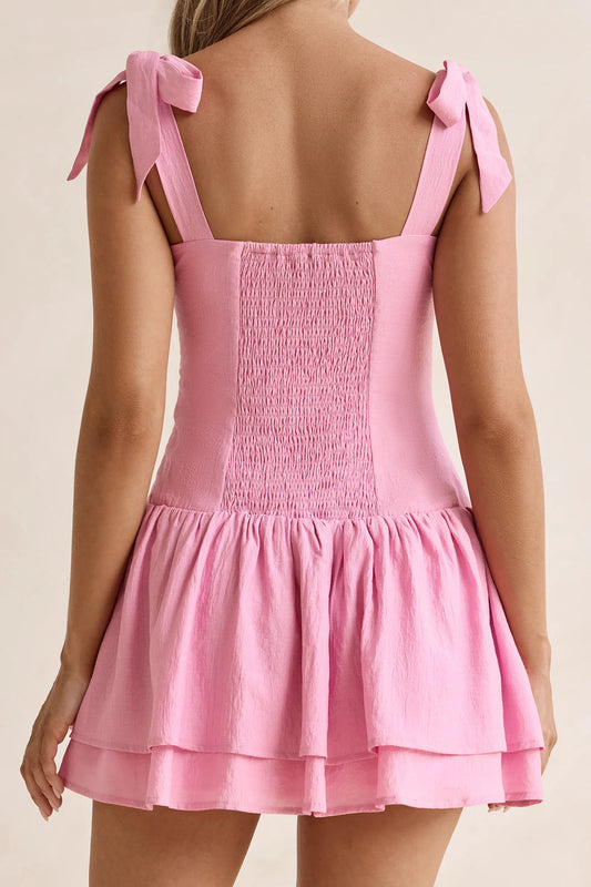 Back view of the pink mini dress, showcasing the shirred smocked panel.