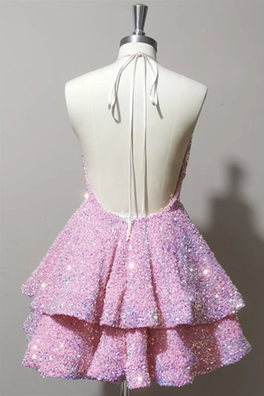 Close-up of the sparkling tiered sequin fabric on a pink short dress.