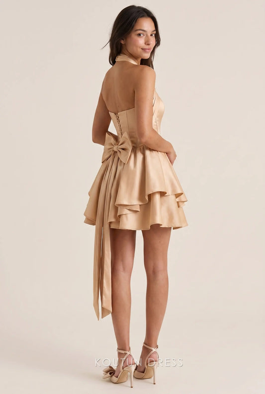 Back view of the Koutun halter neck corset satin mini dress showing lace-up detail and large bow.