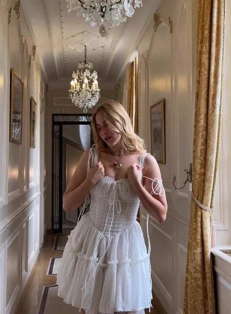 Full length view of the white lace corset dress, showcasing its romantic silhouette.