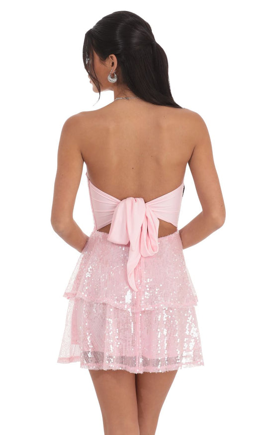 Back view of the pink sequin strapless dress, highlighting the oversized fabric bow.