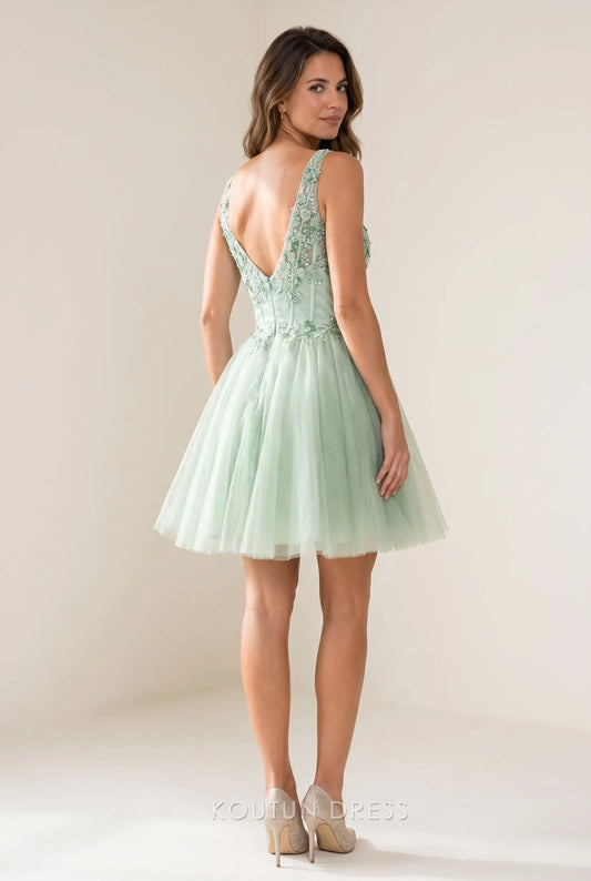 Side view of a model in a sage green glitter tulle mini dress, showcasing the A-line skirt.