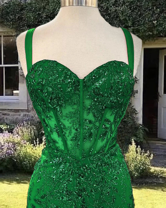 Close-up of a model in a sparkling green sequin prom dress.