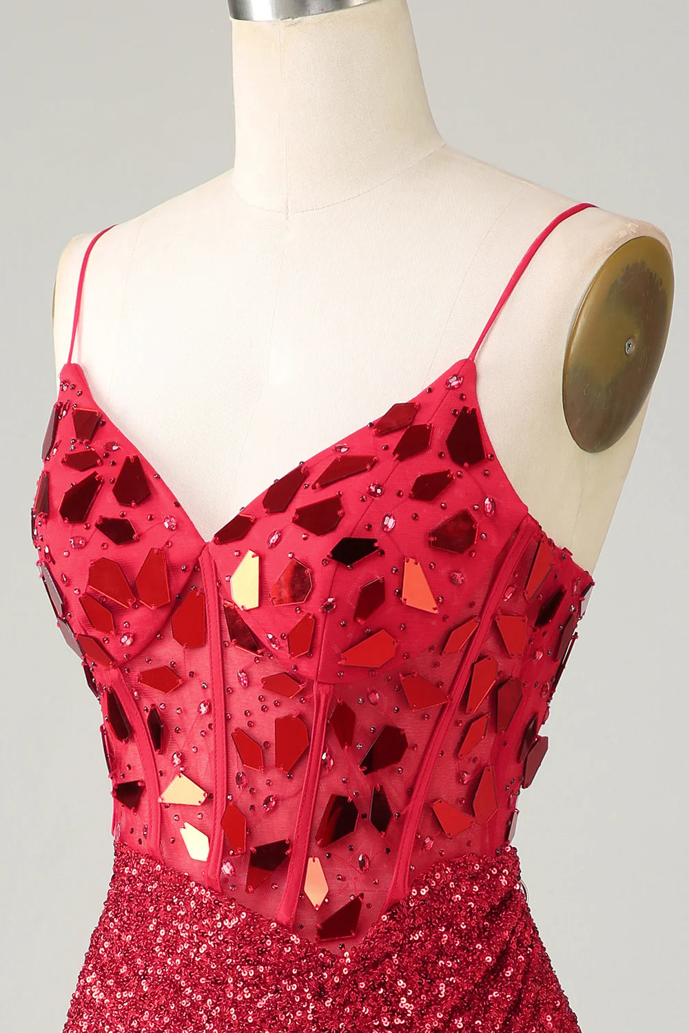 Back view of a red sequin corset dress, highlighting the fitted silhouette.