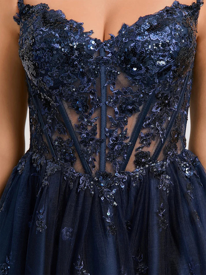 Close-up detail of the intricate sequin and lace embellishments on the V-neck homecoming dress.