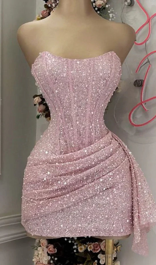 Back view of a model wearing the pink sequin strapless homecoming dress.