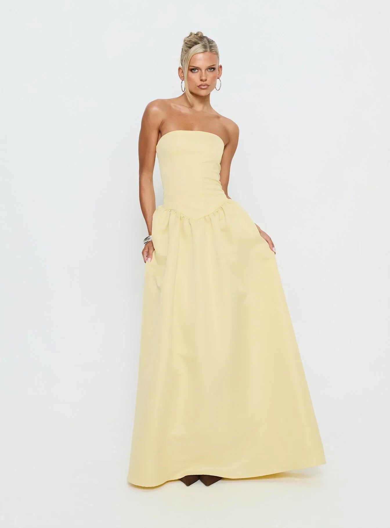 Yellow Strapless Prom Dress with Structured Corset Bodice and Voluminous Ball Gown Skirt for Formal Events and Prom Nights