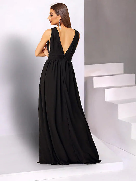 Side view of a woman in a black chiffon V-neck dress, showcasing the flowing fabric and elegant drape.
