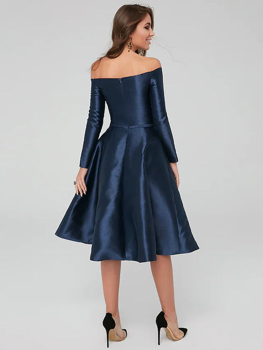 Side view of a woman in a dark blue off-shoulder pleated satin dress.