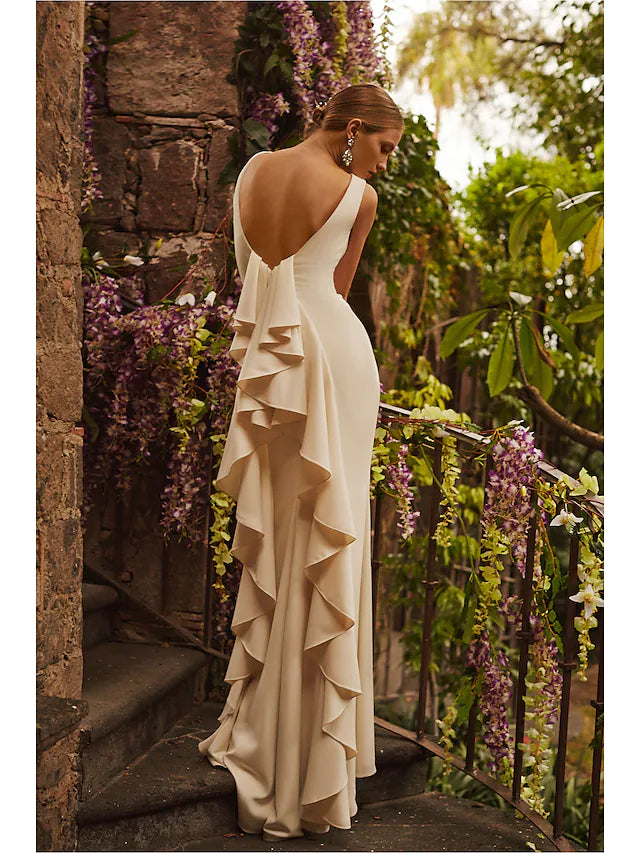 Close-up of the bateau neckline and delicate draping on the charmeuse wedding gown.