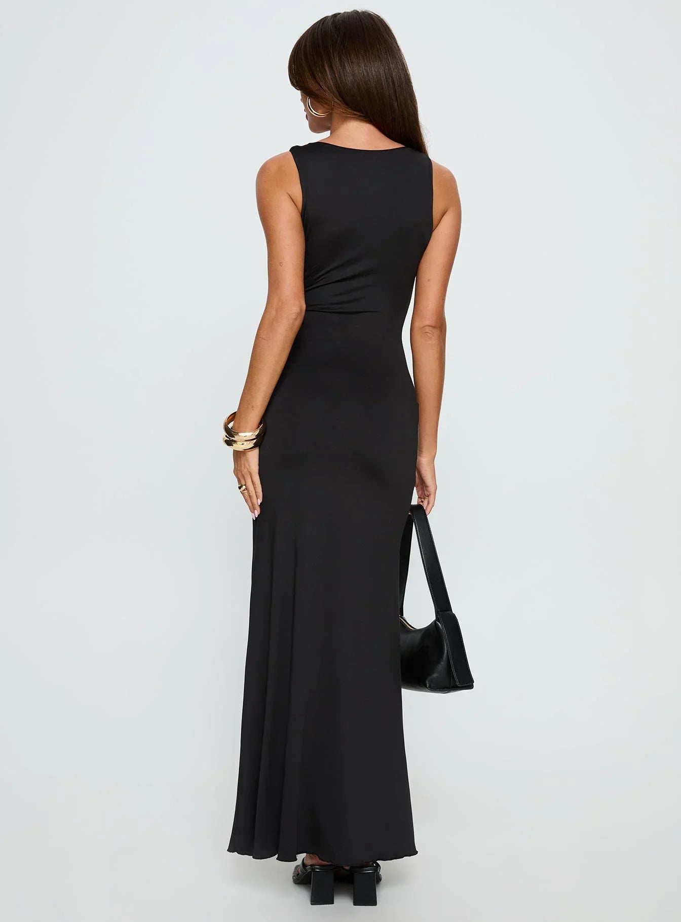 Black Sleeveless Prom Dress with Gold Flower Detail and Mermaid Silhouette for Formal Events and Prom Nights