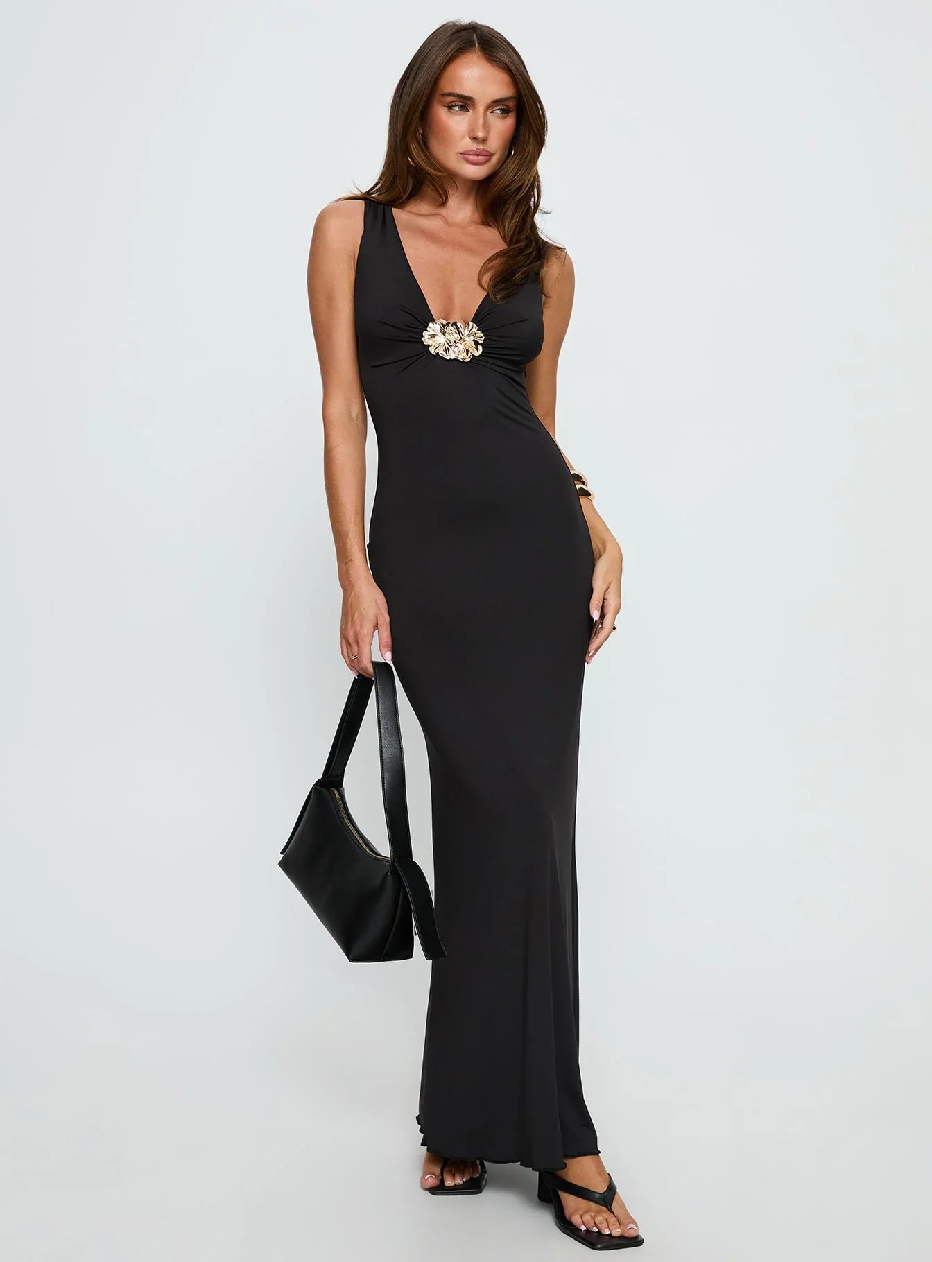 Black Sleeveless Prom Dress with Gold Flower Detail and Mermaid Silhouette for Formal Events and Prom Nights