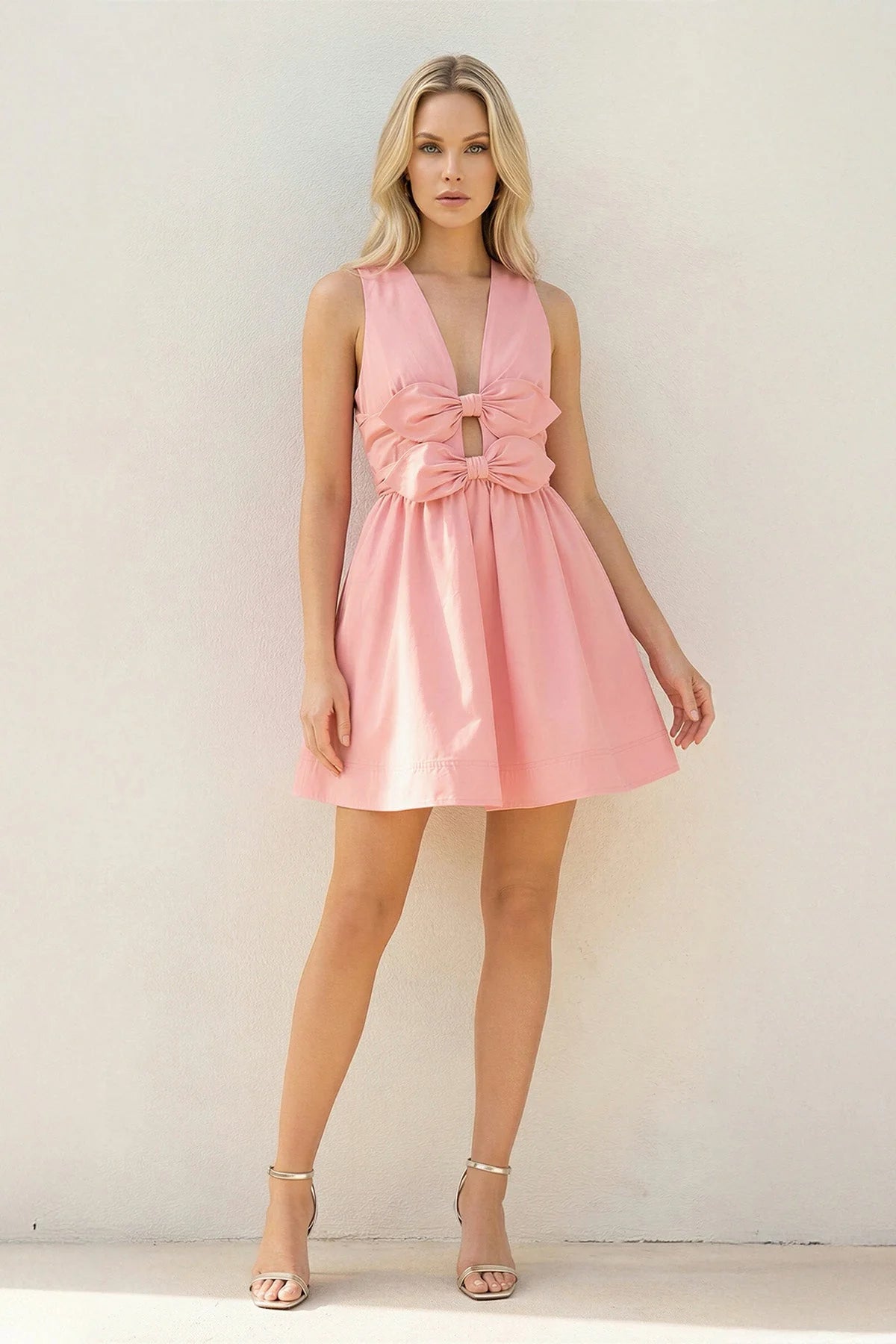 Side view of a blush pink A-line mini homecoming dress.