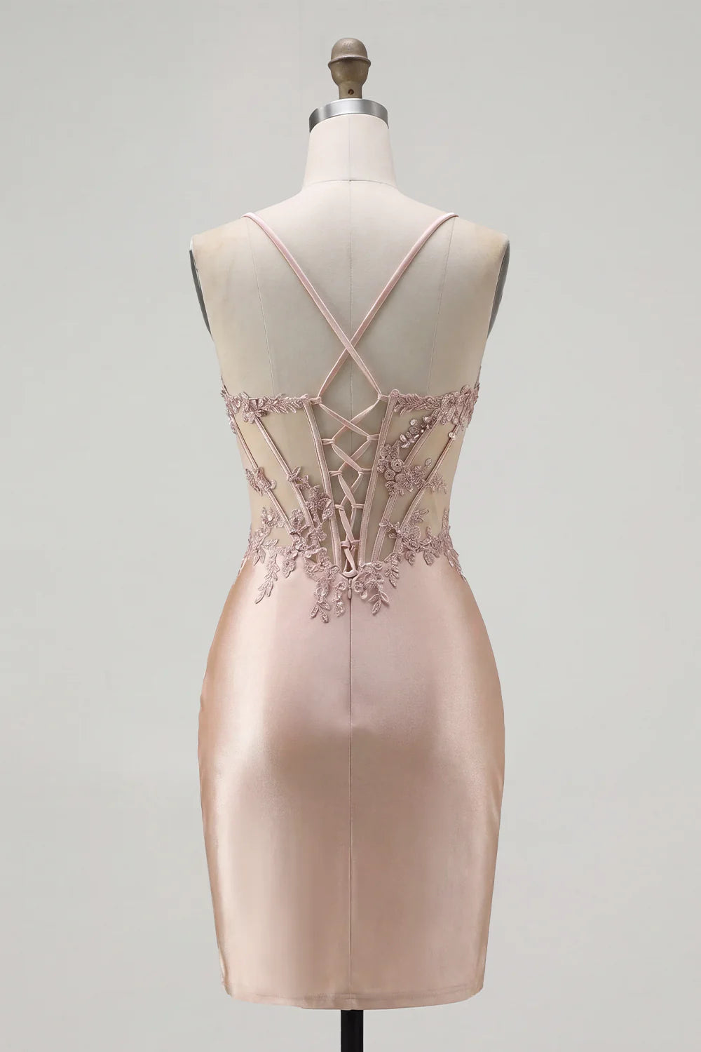 Side view of the blush pink mini dress, emphasizing the short length and lustrous satin fabric.
