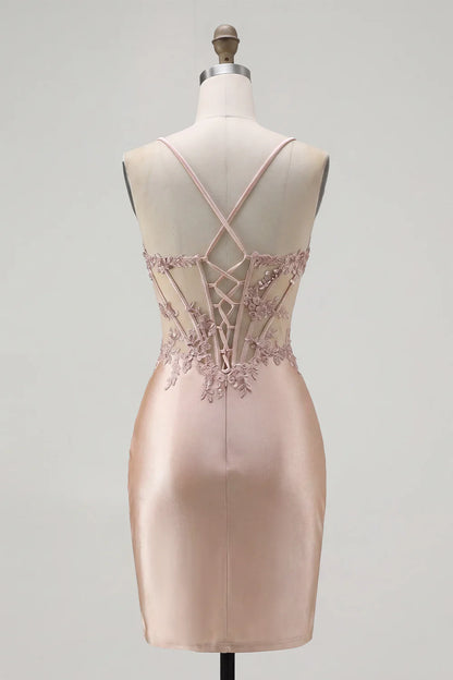Side view of the blush pink mini dress, emphasizing the short length and lustrous satin fabric.