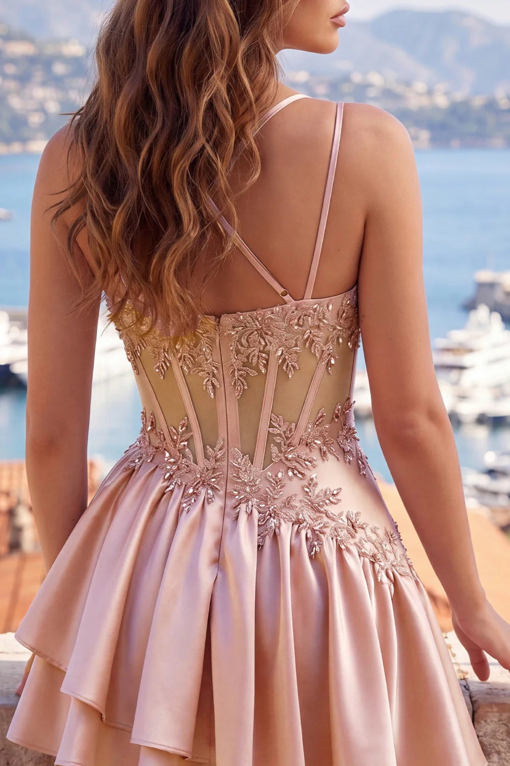 Side view of model wearing blush pink spaghetti strap dress.
