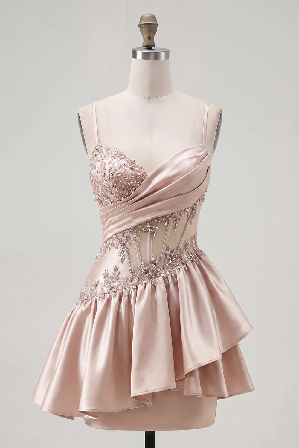 Blush pink mini dress with ruffled skirt and spaghetti straps.