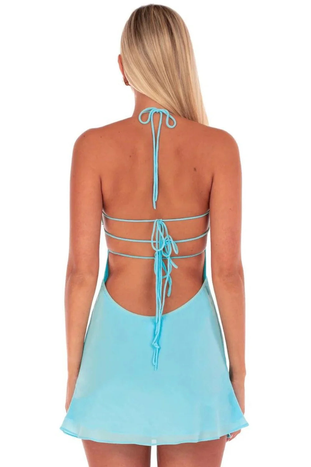 Open back tie-back detail of turquoise chiffon mini dress.