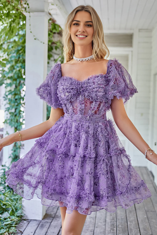 Model wearing an off-shoulder A-line printed tulle homecoming dress, front view.