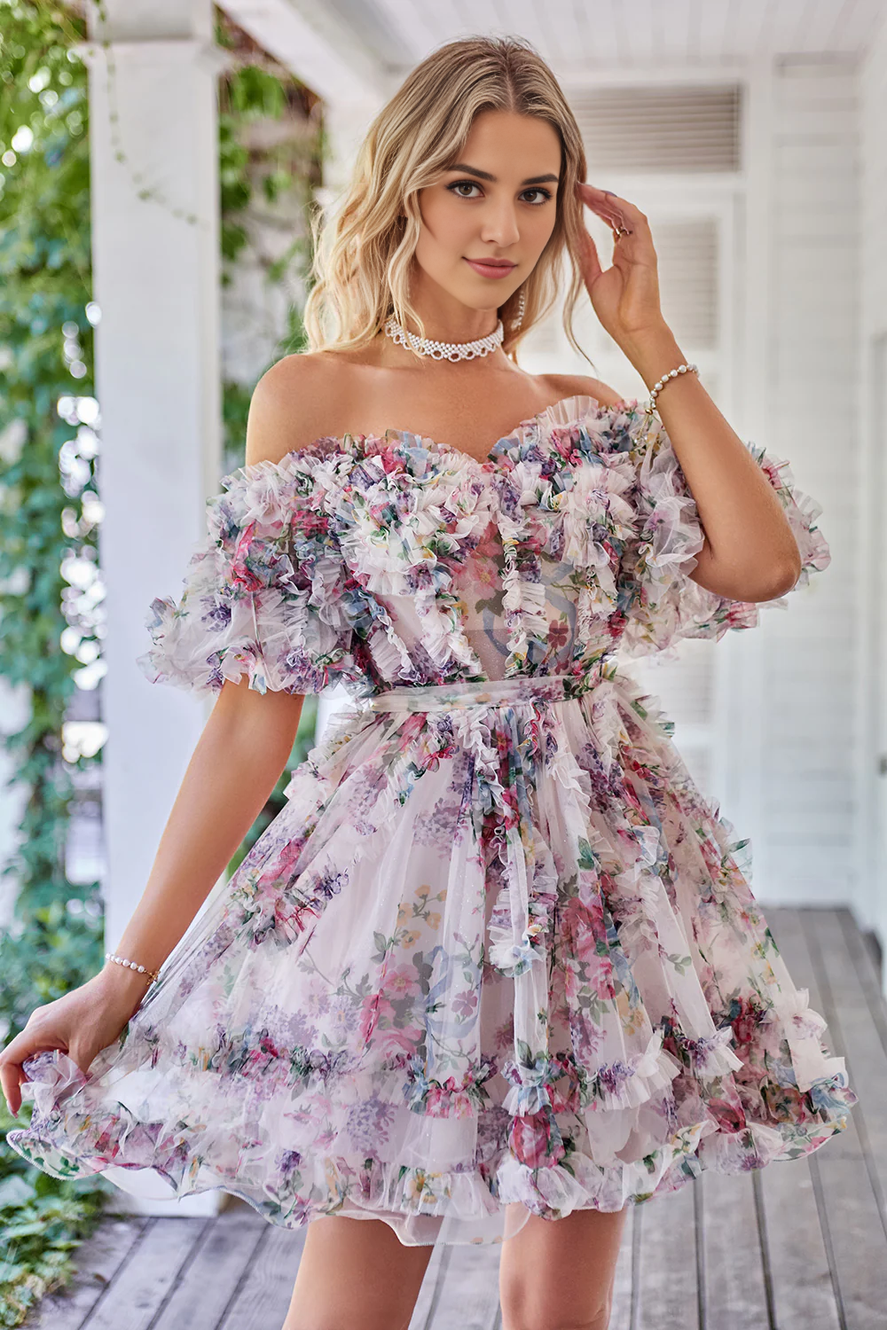 Model posing gracefully in the off-shoulder A-line printed tulle dress.