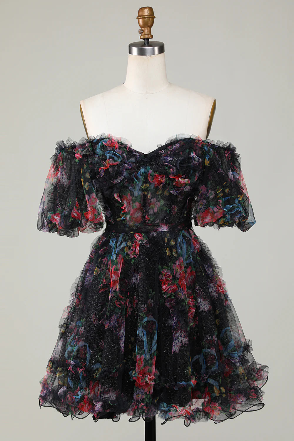 Detail of the off-shoulder neckline and printed pattern of the tulle dress.