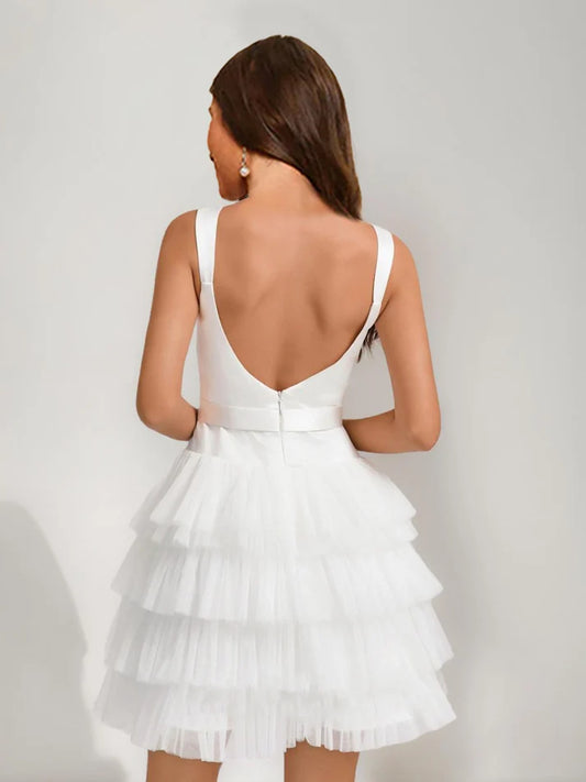 Back view of A-line princess short homecoming dress with tiered skirt.