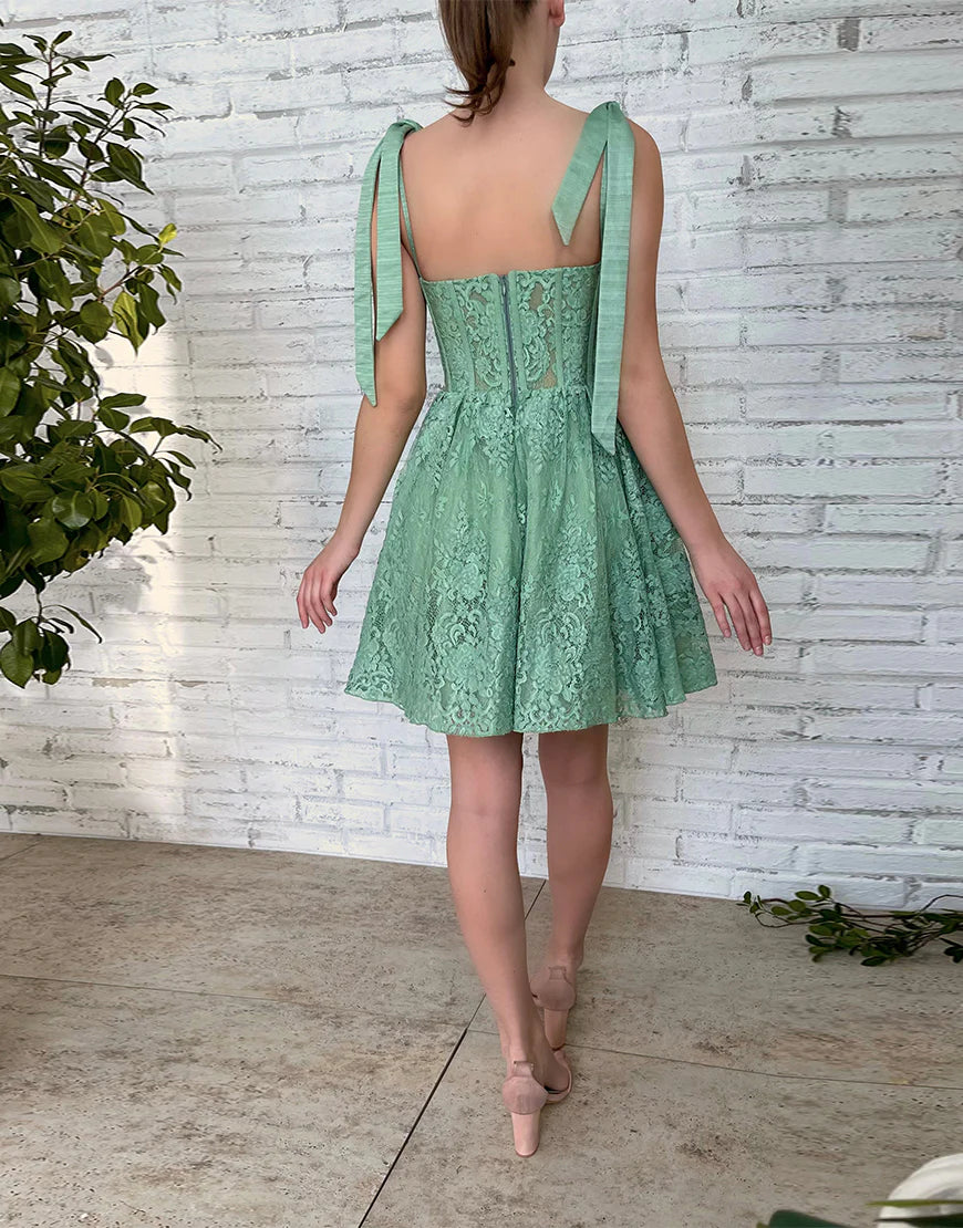 Side profile of a model in the green A-line sweetheart dress.