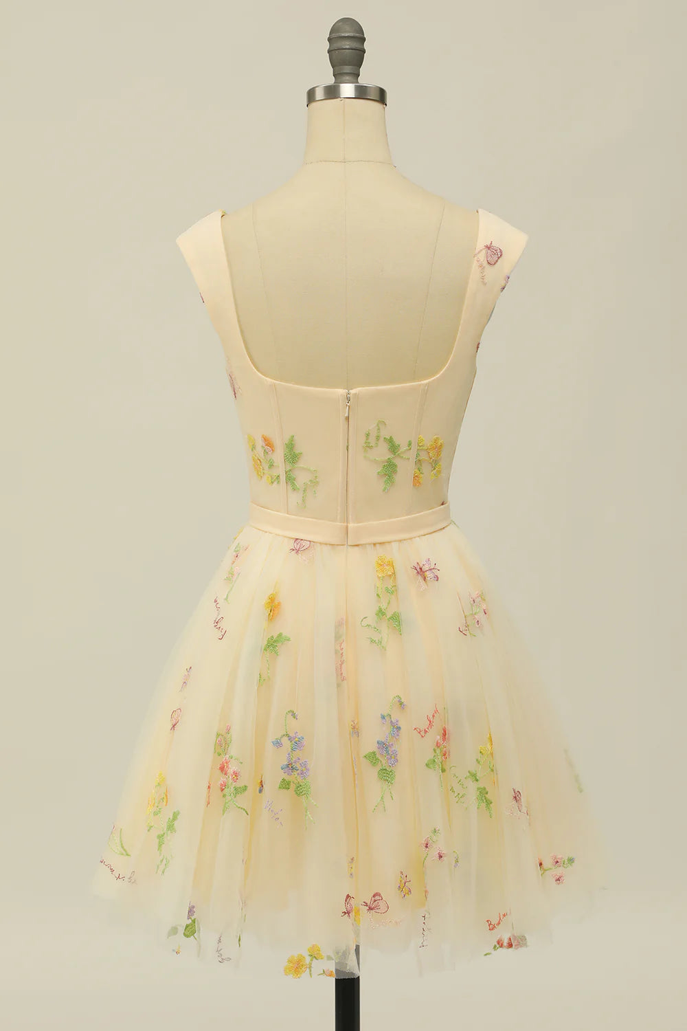 Back view of a model in a grey-blue floral print A-line homecoming dress.