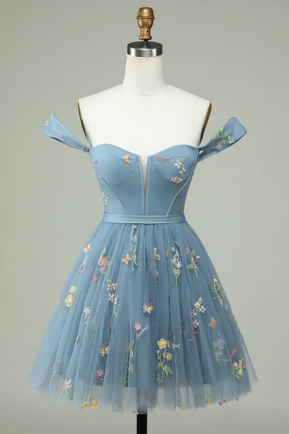 Close-up of the grey-blue floral print and sweetheart neckline on the dress.