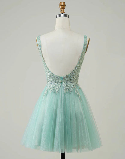 Model wearing a pink A-line V-neck homecoming dress with appliques.