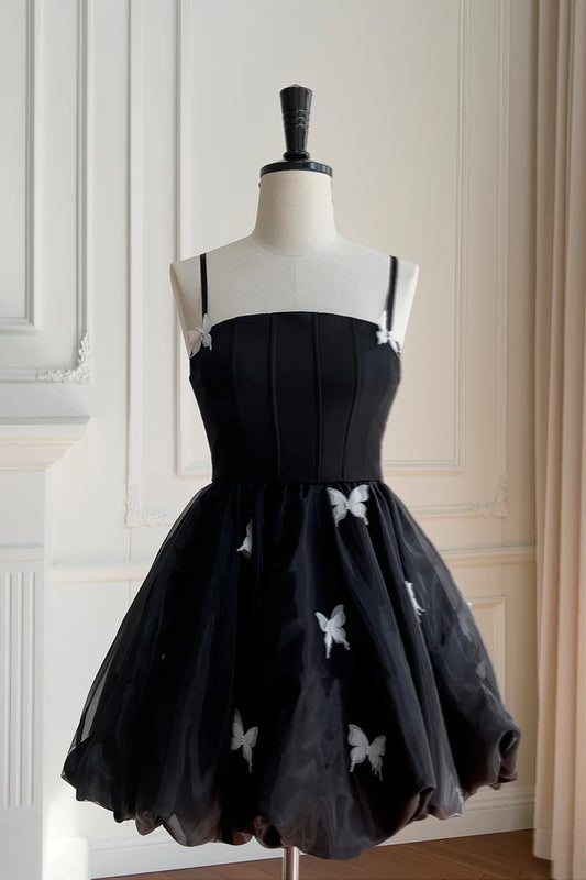 Model wearing Koutun black homecoming dress with A-line silhouette.