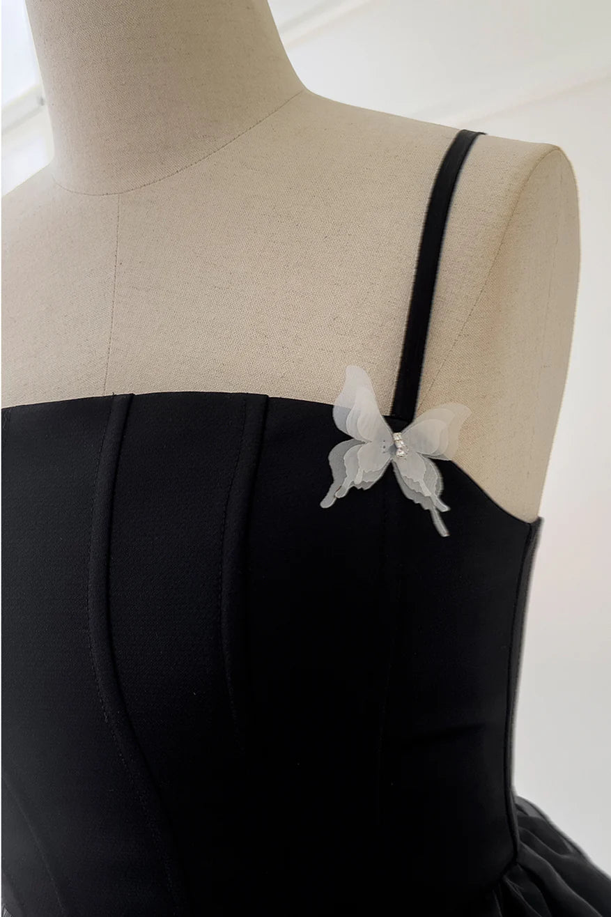 Koutun black party dress with elegant straps and butterfly embellishments.