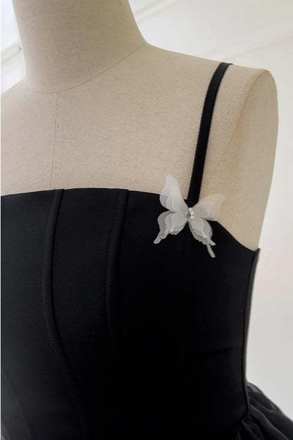 Koutun black party dress with elegant straps and butterfly embellishments.