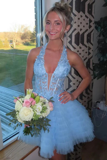 Charming A-line halter homecoming dress with applique and layered skirt.